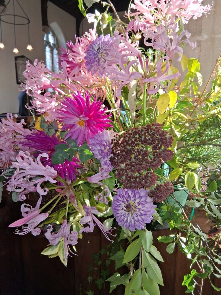 Church flowers, including Dahlias, Nerine lilies, and Sedum.